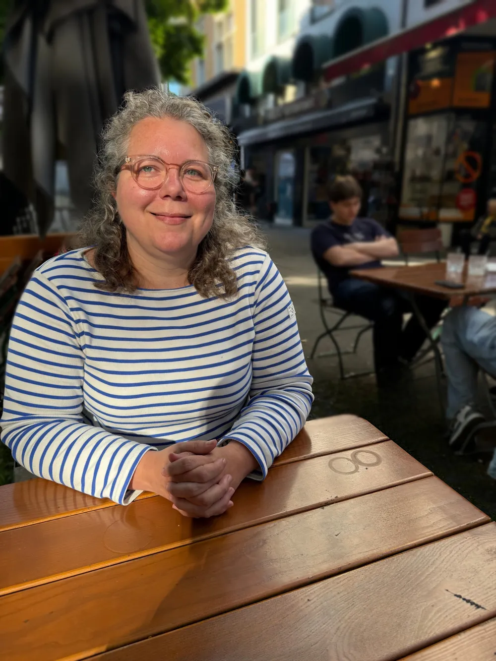 Marcia Adair at a café table in Cologne