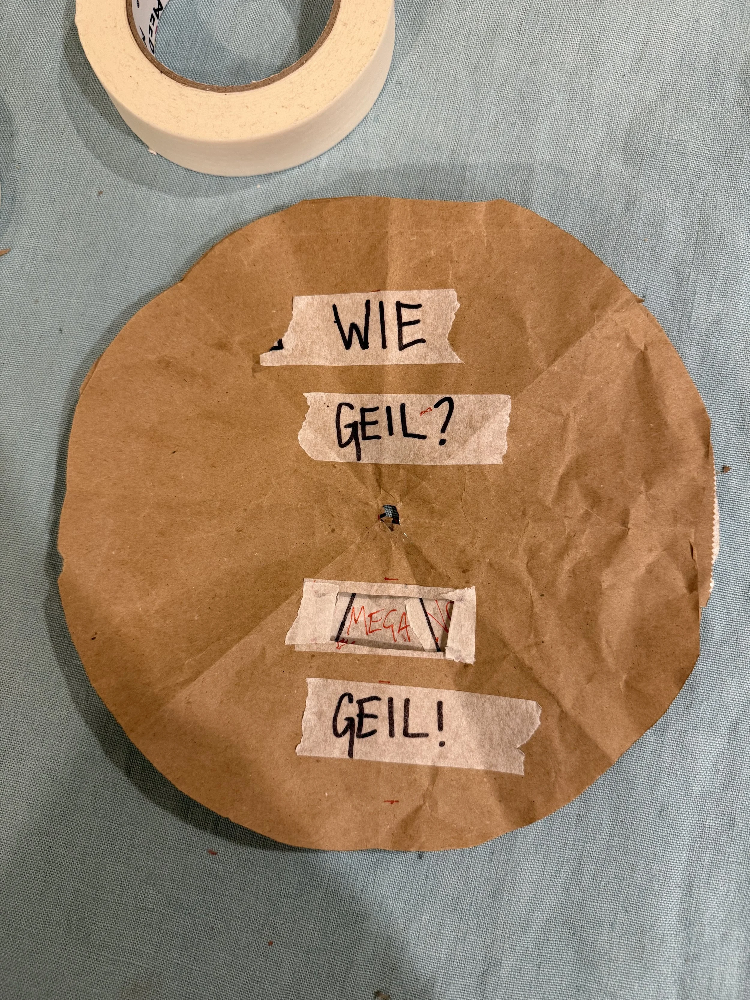 The Geil-o-Mat prototype, a spinning wheel made from a paper bag and masking tape